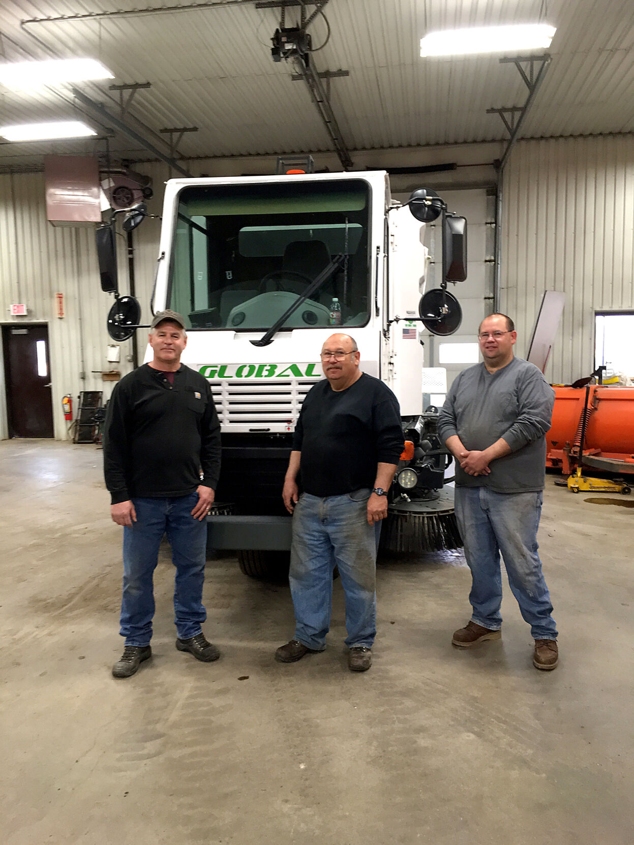 The Aitkin Street Department crew in 2017 – Greg Handt, Bob Nicko and Lon Nicko – with the new street sweeper.